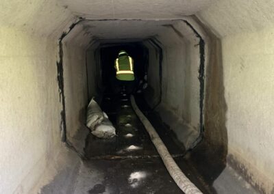 Worker working inside long underground tunnel