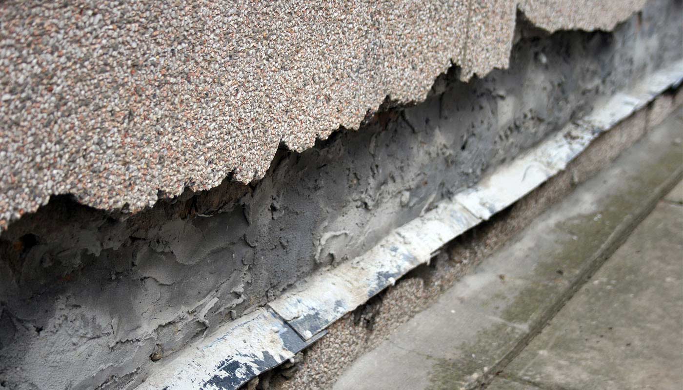 cracking basement wall loosing layer of finish