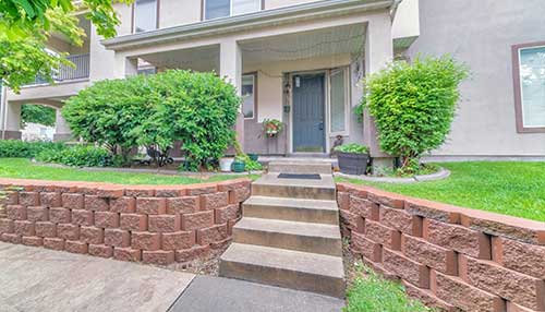 Front of home with repaired porch stairs