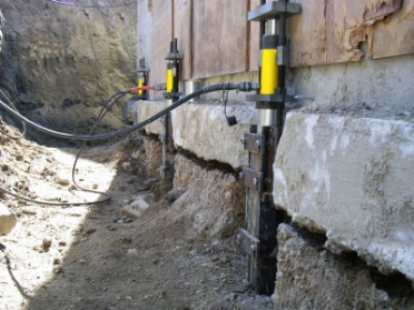 Foundation Repair Tools being used outside a house